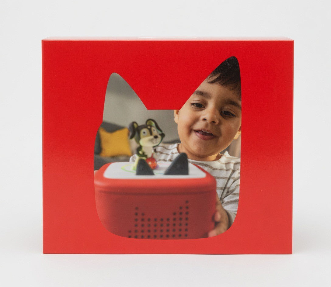 ImagineHaul red Toniebox 2 starter set with dog figure, featuring a smiling child interacting with the screen-free audio player.
